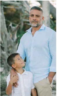 Luke Pyszczymuka looking up at his father Martin during a family photo session