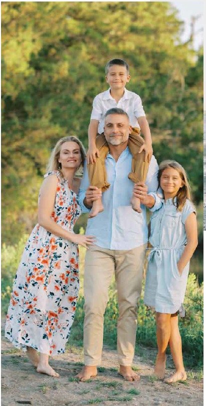 Martin Pyszczymuka carrying his son Luke on his shoulders beside Ava and Amelia among coastal trees