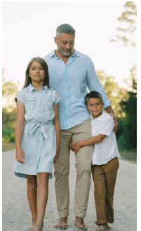 Martin Pyszczymuka standing with Amelia and Luke on a sandy coastal path